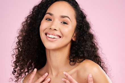 Face, skincare and beauty of happy woman in studio isolated on a pink background. Portrait, smile and natural model with cosmetics in spa facial treatment for aesthetic, wellness and healthy skin, a Photo by Peopleimages.com