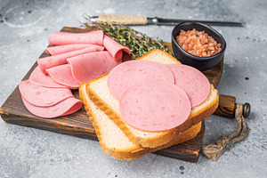 Slices of pink bologna lunch meat on toasted white bread with ro, a Food & Drink Photo by composter-box@mail.ru