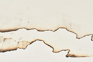 Burnt edges of blank white notebook sheets, a Background Photo by ndanko