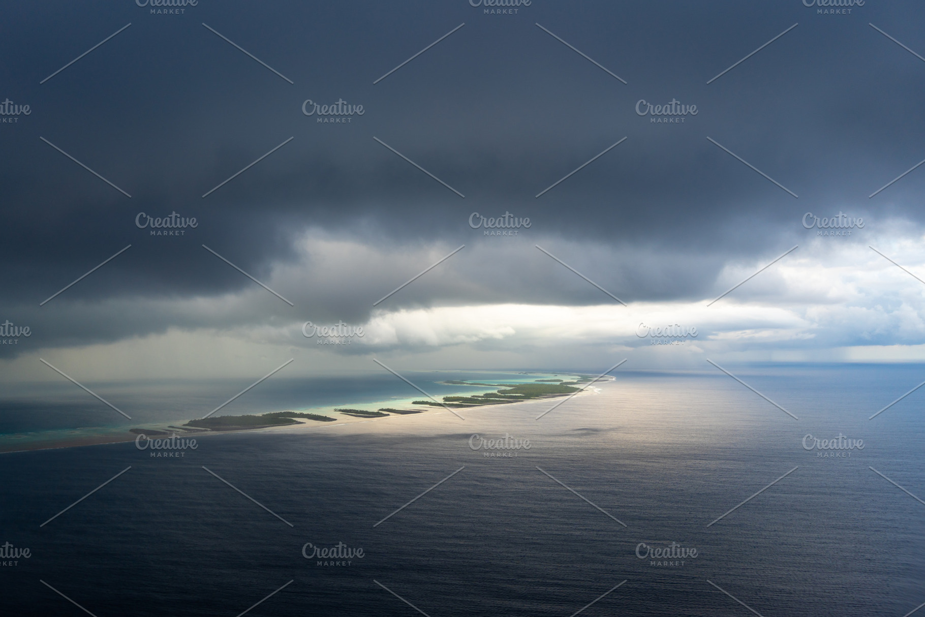 Aerial view of Rangiroa Atoll under a stormy sky, Tuamotus, Fren, a Nature Photo by GoodGoods