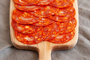 Cold Meat Chorizo Slices on a Wooden Board, side view., a Food & Drink Photo by LiudmylaChuhunova