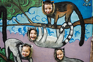 Children enjoying interactive animal cutouts at a vibrant zoo exhibit display, a Photo by AS photostudio