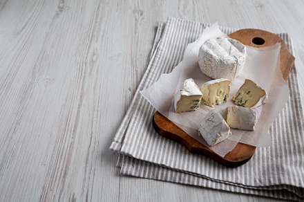 Alpine Blue Cheese on a rustic wooden board, side view. Space fo, a Food & Drink Photo by LiudmylaChuhunova
