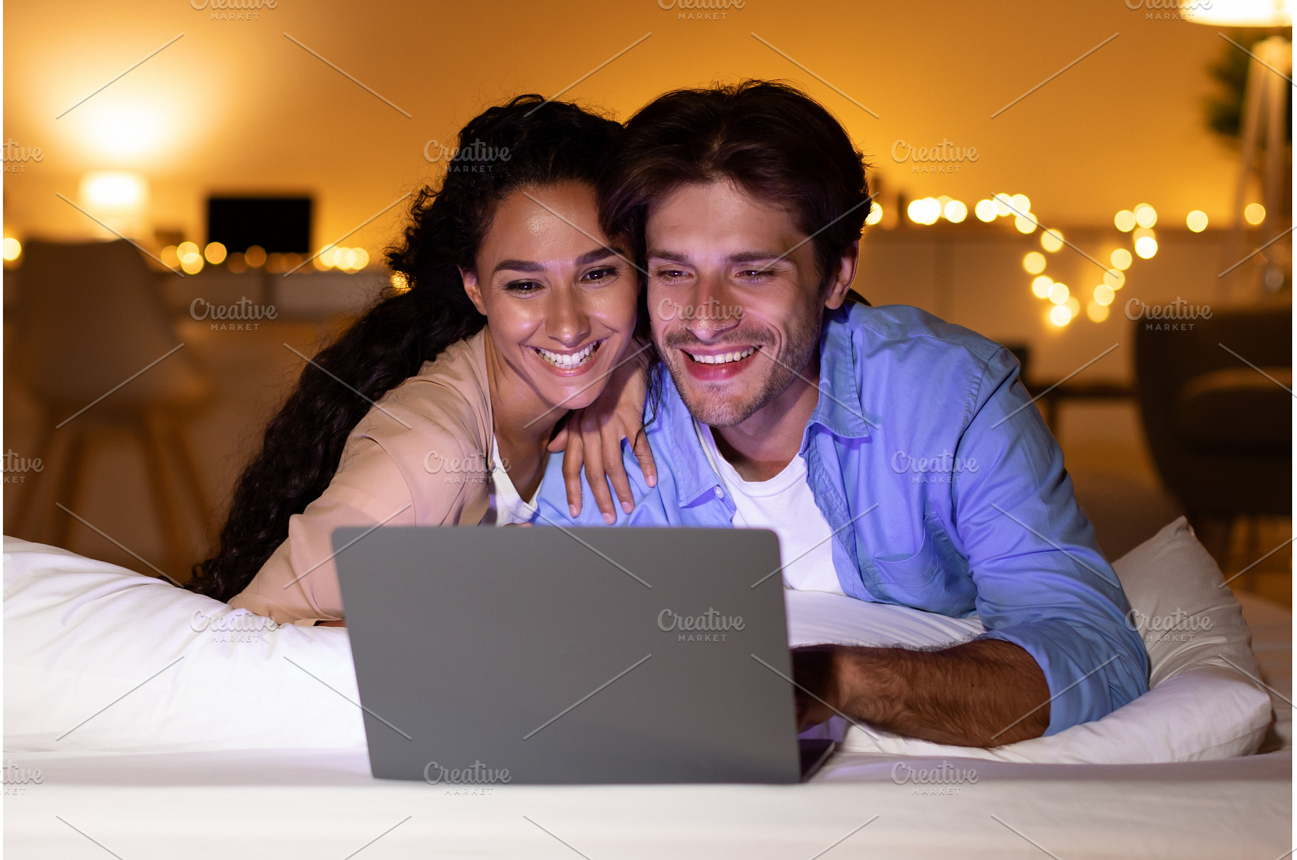 Smiling Couple Using Laptop Watching, a Person Photo by Prostock-Studio