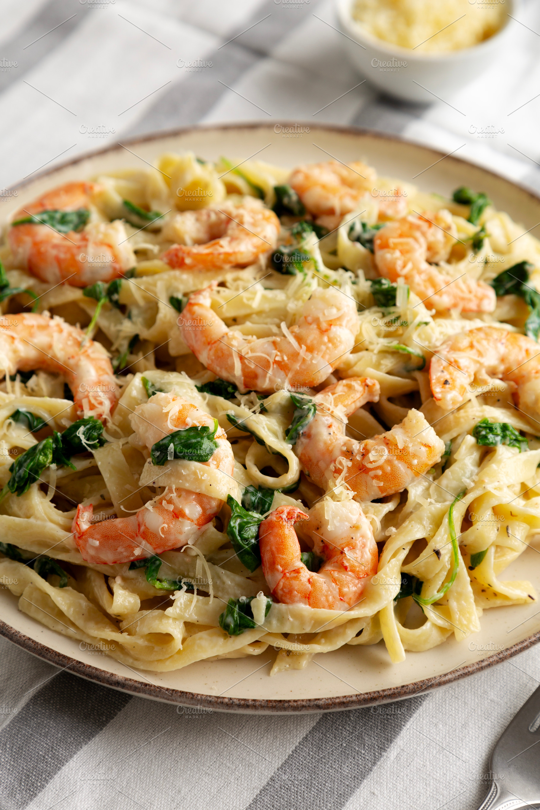 Homemade Creamy One-Pot Spinach Shrimp Pasta on a Plate, side vi, a Food & Drink Photo by LiudmylaChuhunova