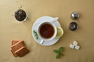 Teacup isolated in the center on brown tablecloth with ingredien, a Food & Drink Photo by Davizro's Market
