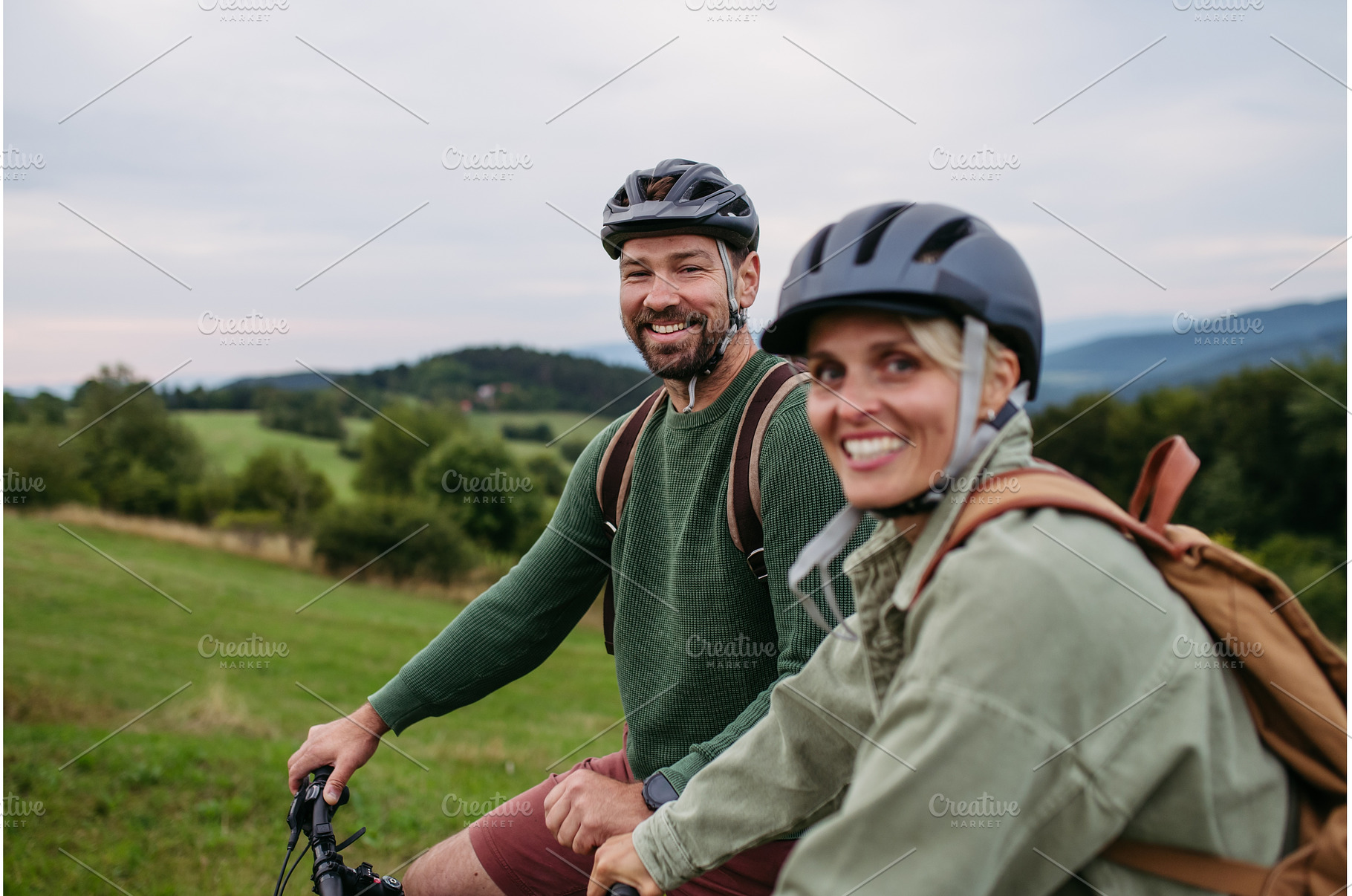 Couple cycling together in nature, a Sports & Recreation Photo by HalfPoint