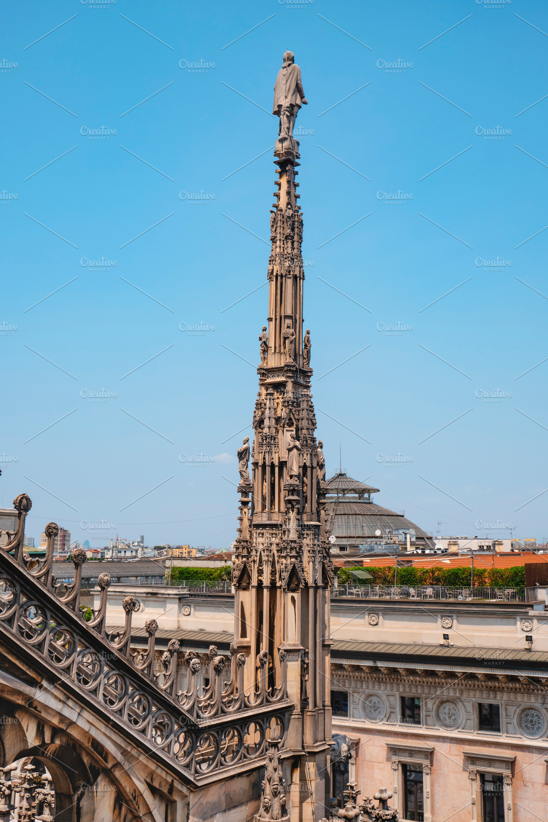 a pinnacle rises over Milan and the Galleria, a Photo by Nito