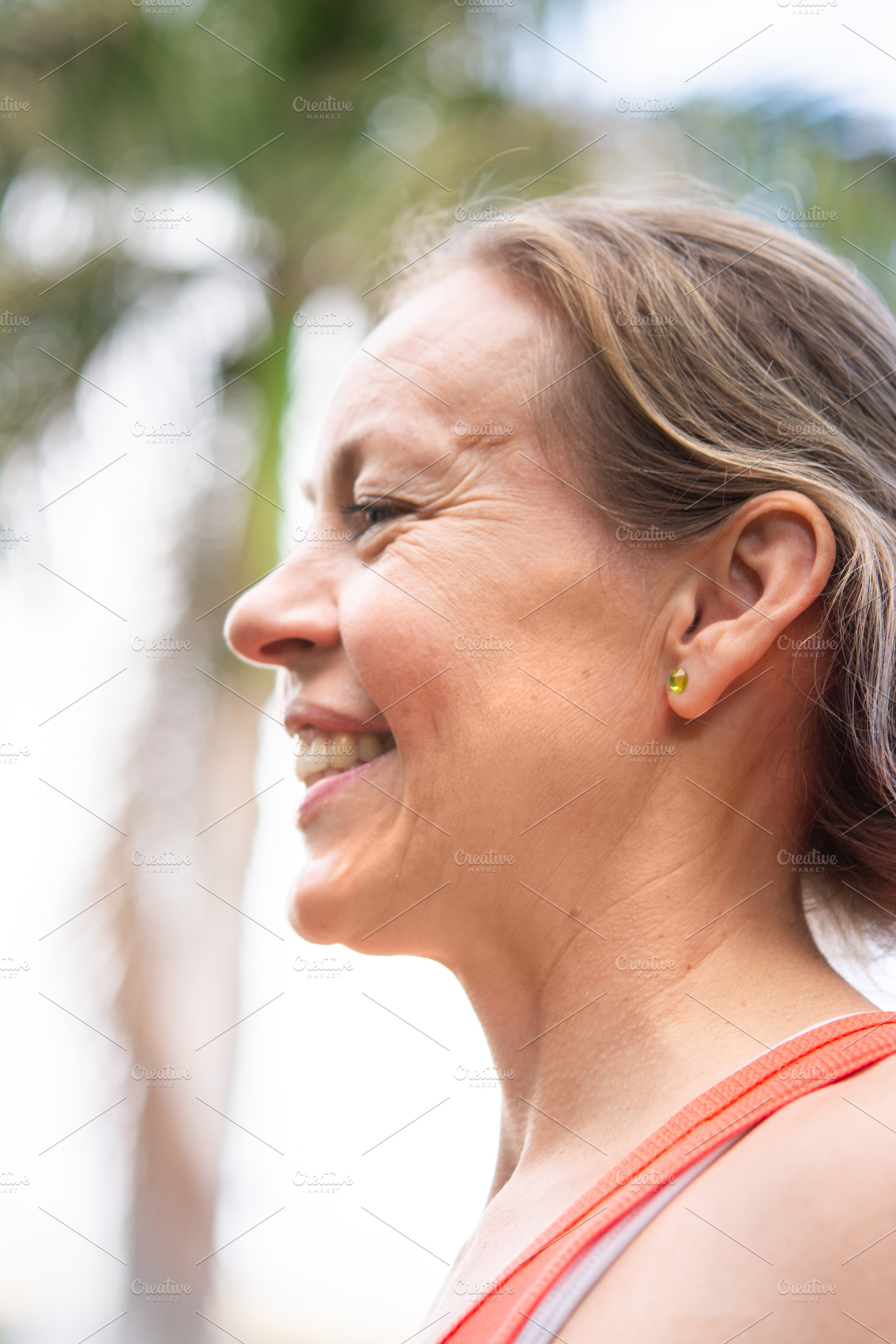 Smiling mature woman profile portrait outdoors after fitness workout, a Sports & Recreation Photo by etorres69