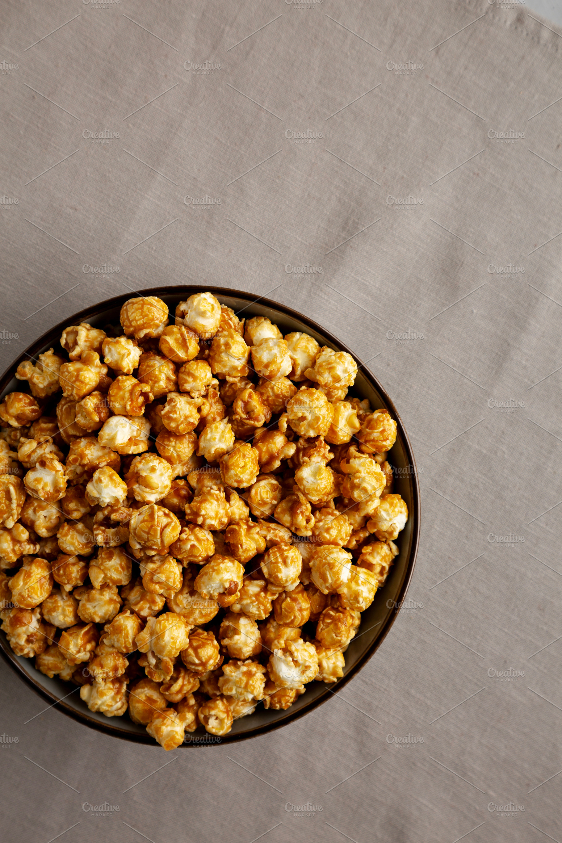 Homemade Caramel Pop Corn in a Bowl, top view. Copy space., a Food & Drink Photo by LiudmylaChuhunova