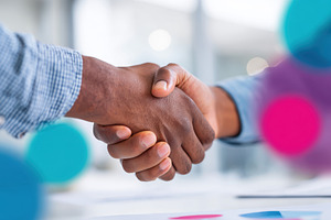 Business handshake on colorful background, a Business Photo by AlyaAnd