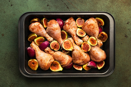 Raw chicken legs, drumsticks with sweet figs and red onions in b, a Food & Drink Photo by 5PH