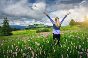 Young woman raising arms standing in, a Person Photo by den-belitsky