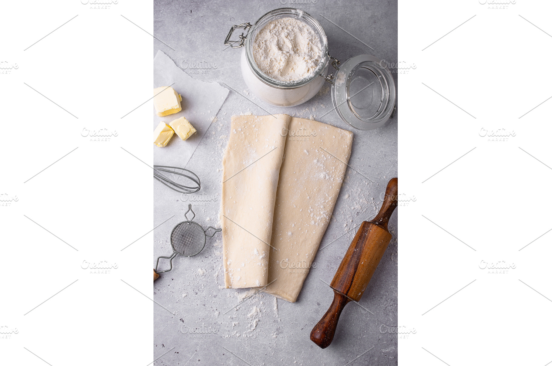 Raw puff pastry dough with baking, a Food & Drink Photo by Yulia Furman