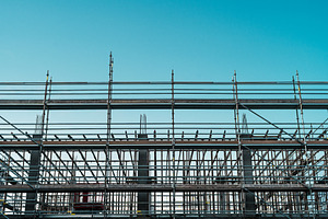 Construction scaffolding under blue sky, an Industrial Photo by SkyNext