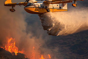 Firefighting plane drops water on wi, a Photo by Pixeness Studio