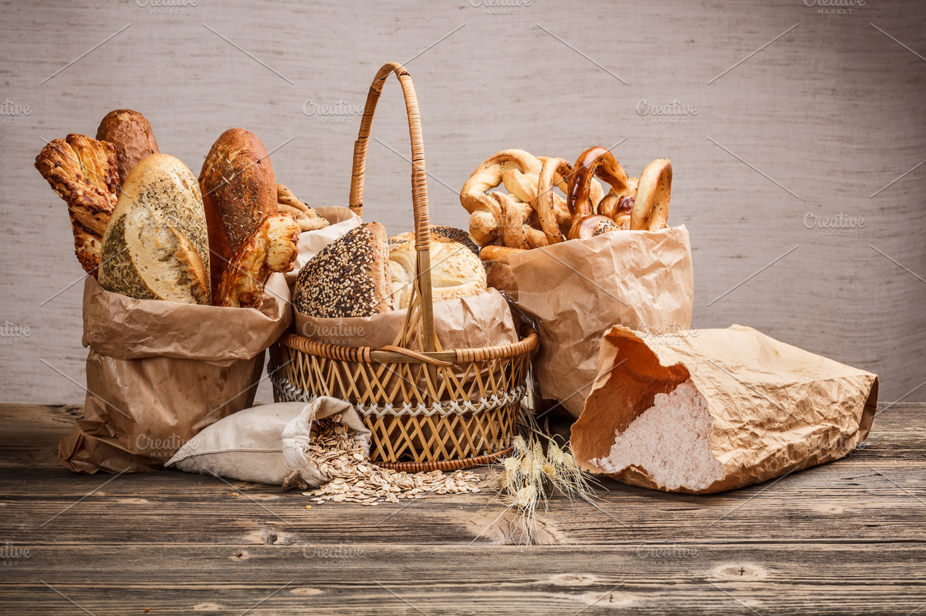 Composition with bread and rolls featuring assortment, bag, and baguette