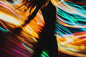 A silhouette of a dancer in motion, surrounded by vibrant, swirling lights in v, a Person Photo by Textures & Backgrounds
