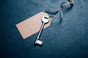 Silver key on blank kraft tag, blue, a Business Photo by Anna Efetova