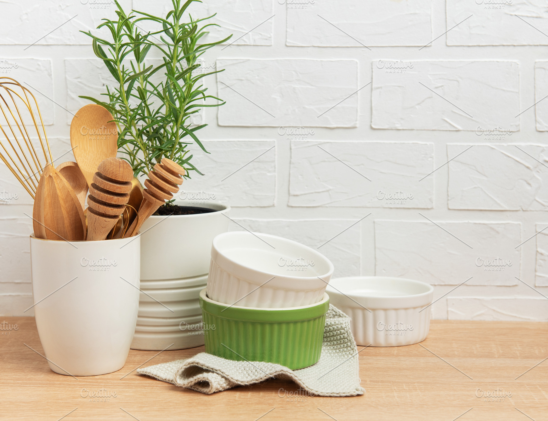 Kitchen utensils, rosemary plant, and ramekins creating a cozy c, a Food & Drink Photo by Olena Rudo