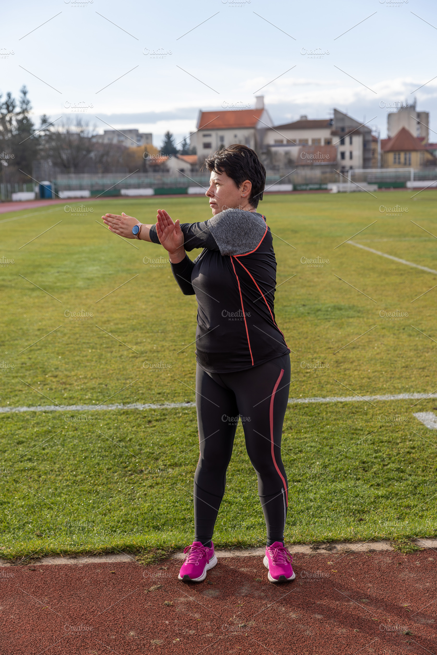 Middle aged woman stretching arms, a Photo by Grafvision photography