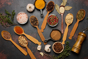 Spices in spoons and bowls on a dark background turmeric, paprik, a Food & Drink Photo by ndanko