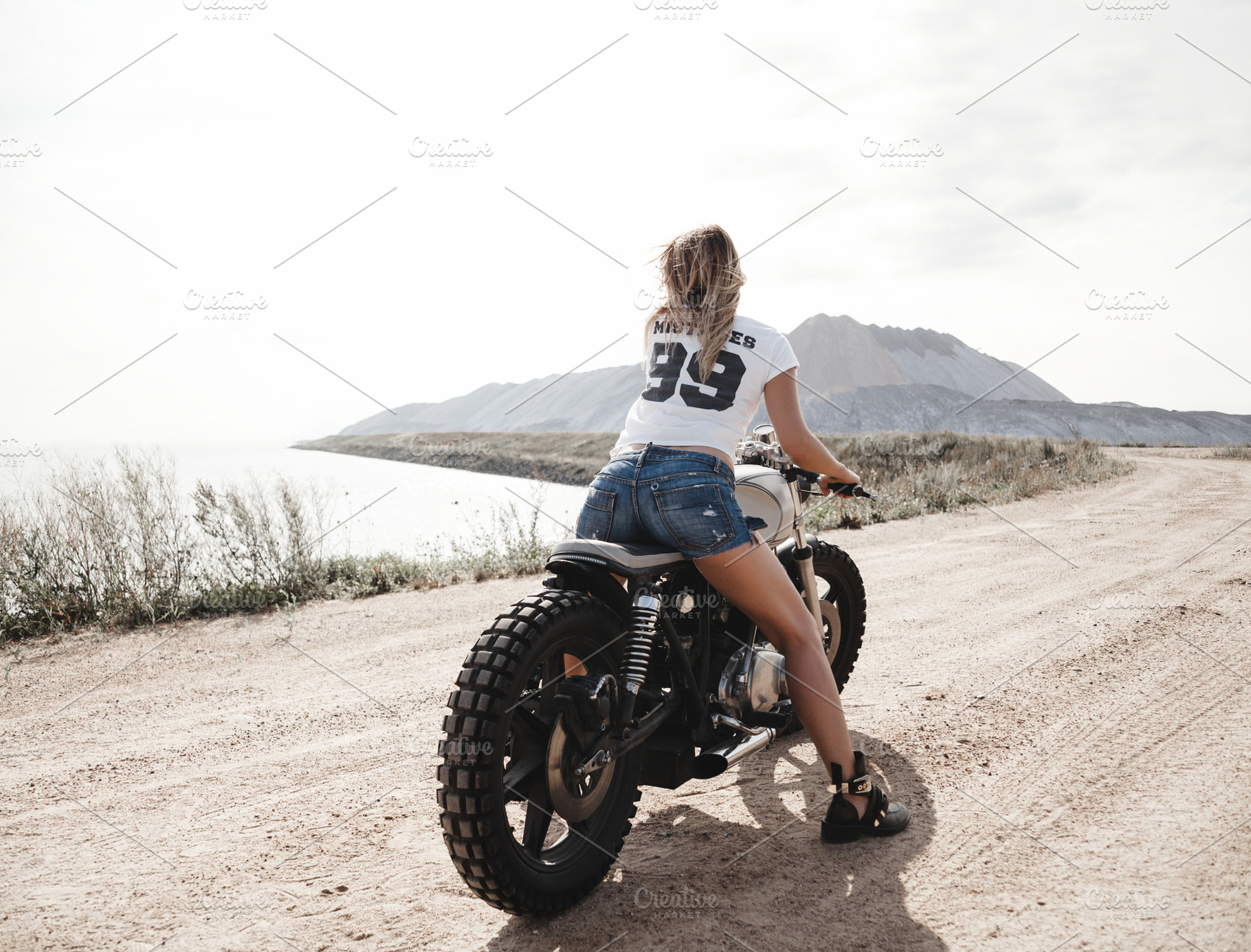 Sexy girl biker and cafe racer featuring wheels, motorcyclist, and female, a Transportation Photo by Aliaksei Kaponia