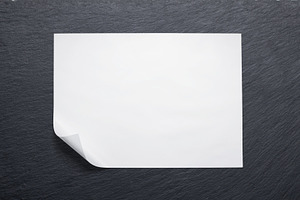 Butcher paper with a folded corner against a slate board