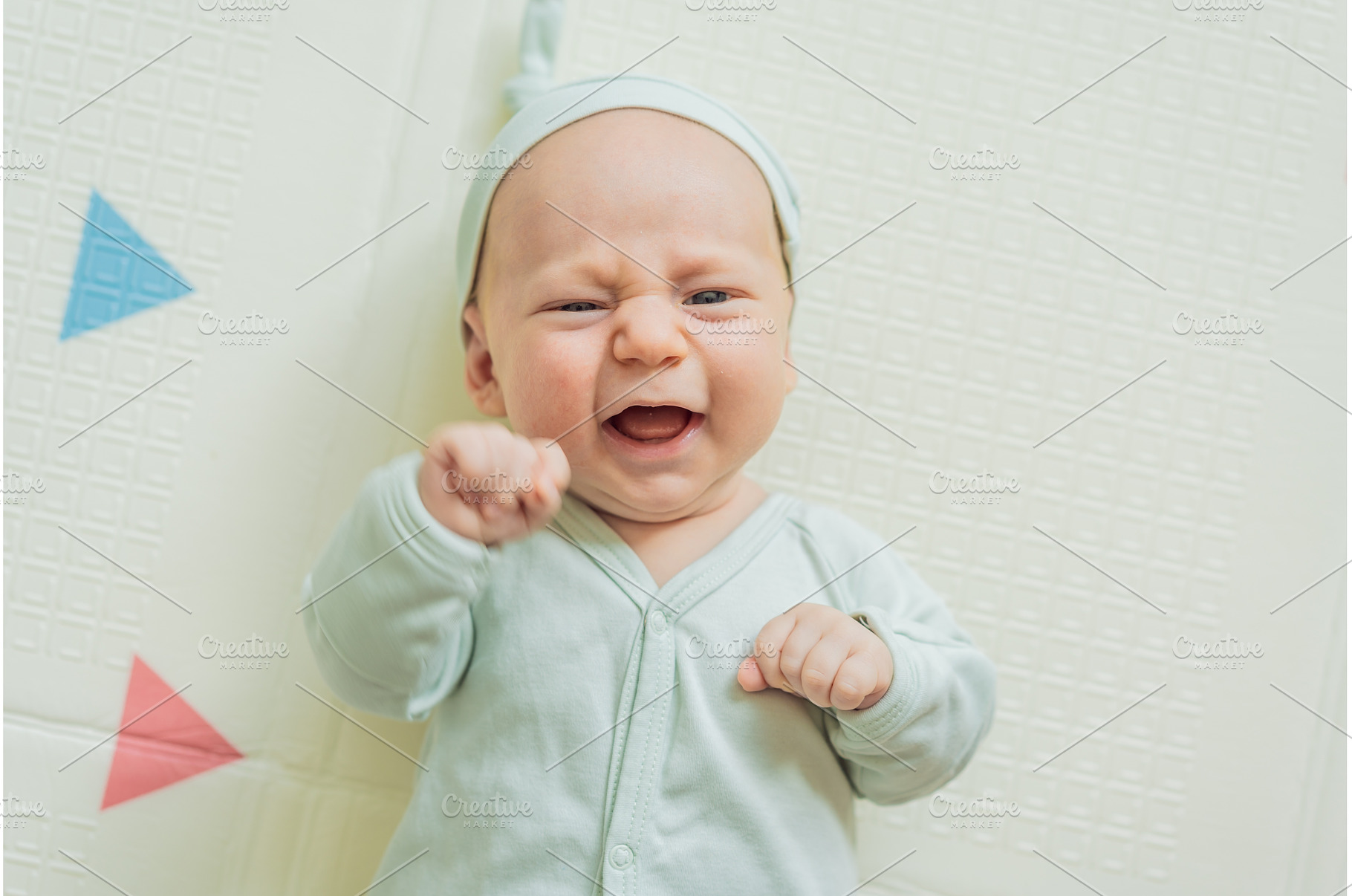 Adorable baby in a green hat lying, a Beauty & Fashion Photo by Elizaveta Galitskaya