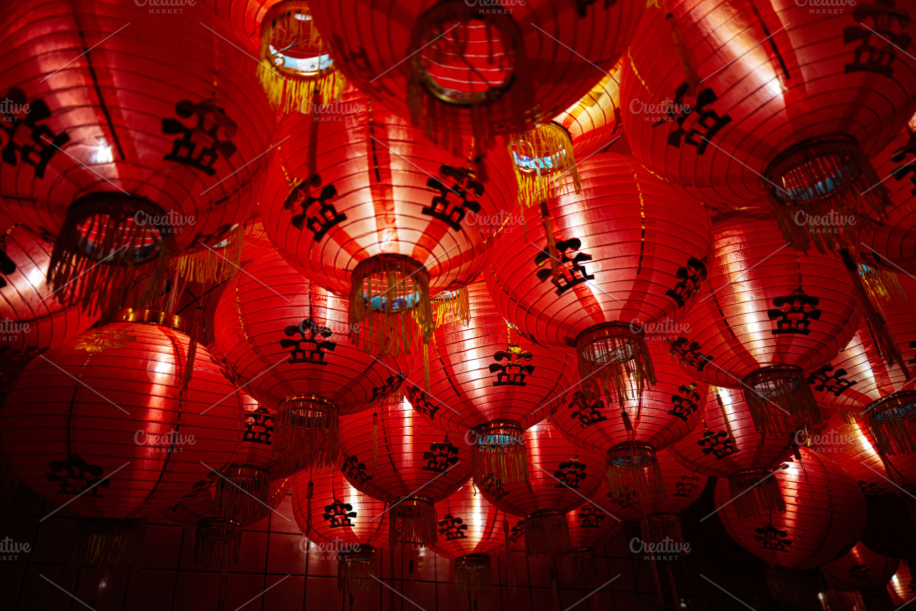 Red lanterns with decorative symbols glowing during a festive celebration, a Photo by AS photostudio