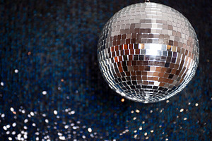 Mirror disco ball hanging from the ceiling containing disco, ball, and mirror