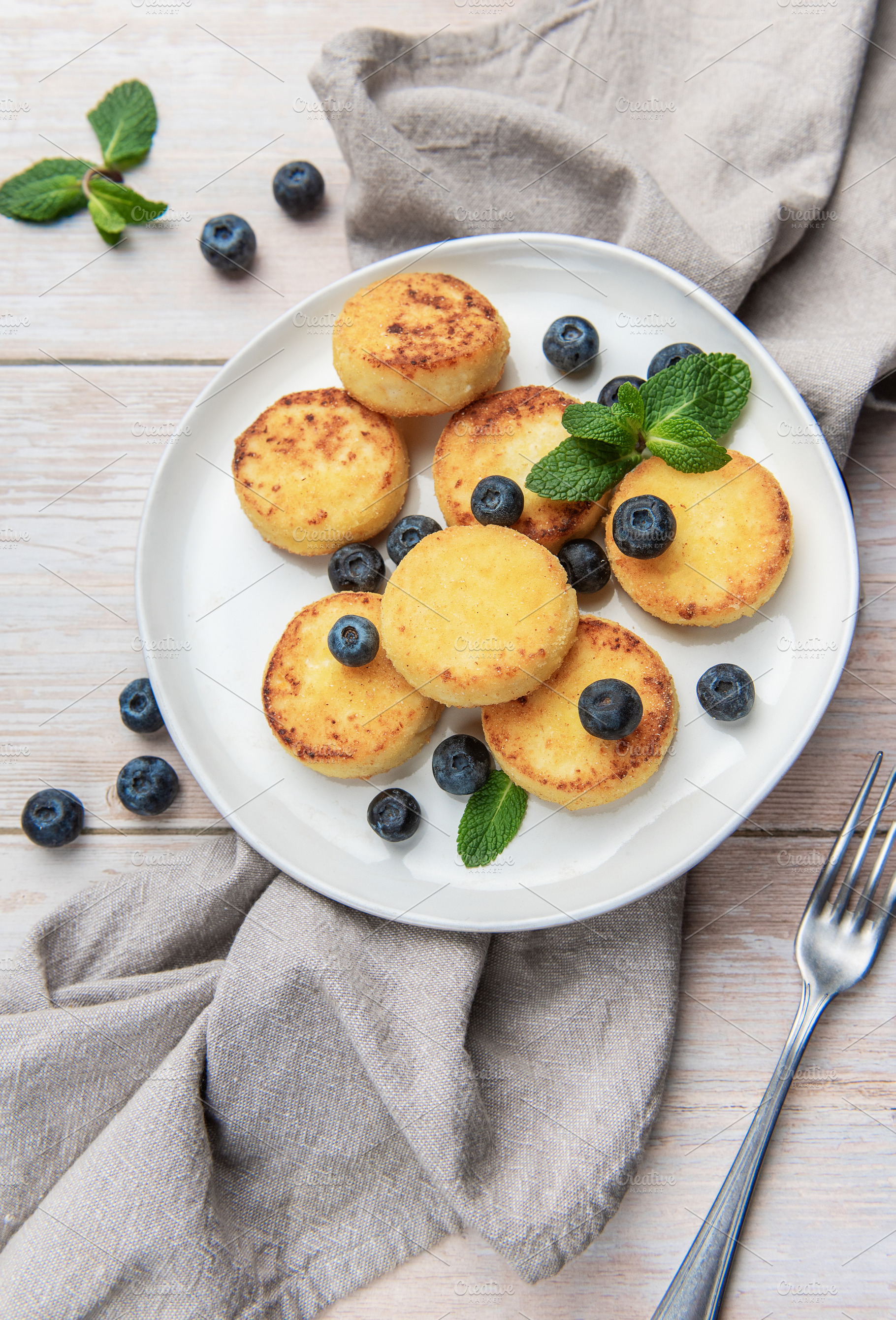 Golden syrniki cottage cheese pancakes with fresh blueberries, a Food & Drink Photo by Olena Rudo