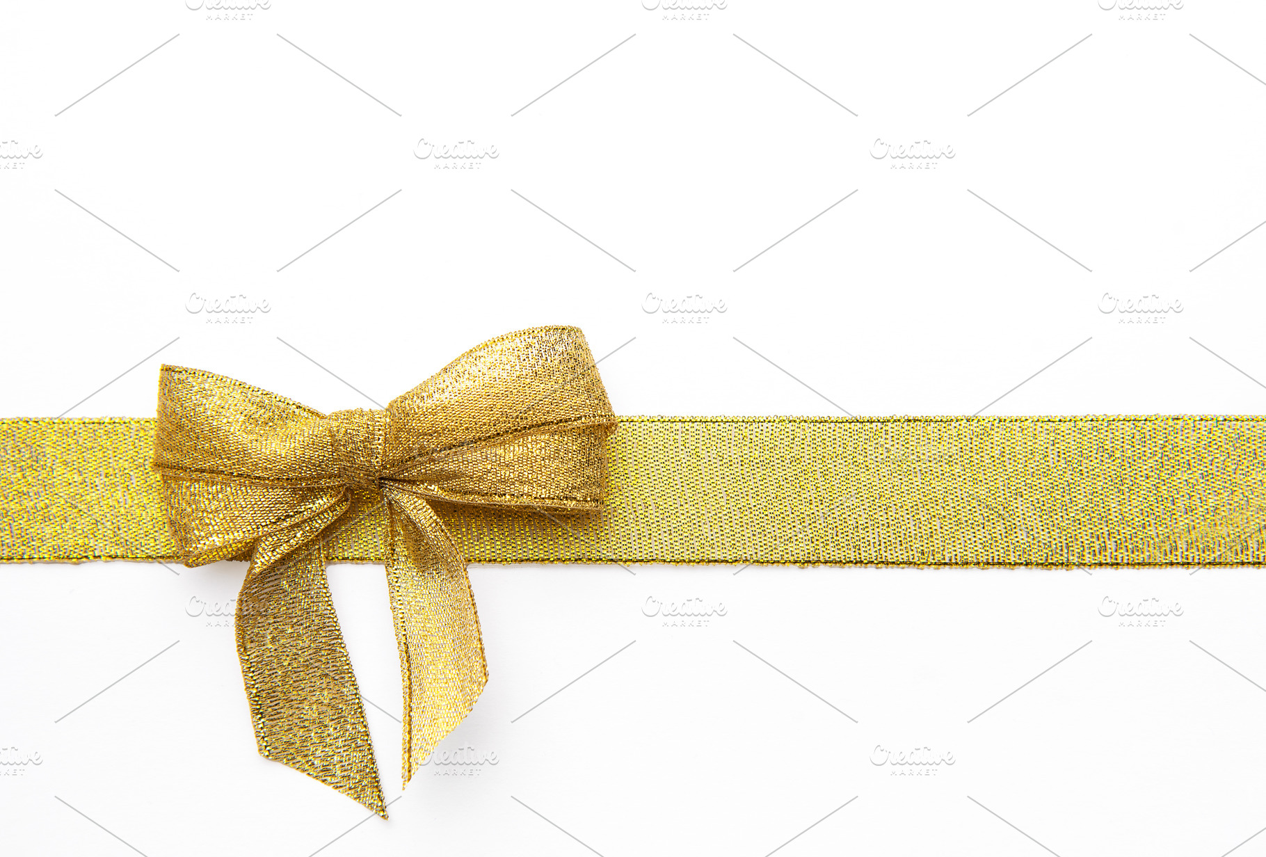 Gold ribbon bow creating a festive background decoration, a Holiday Photo by Olena Rudo