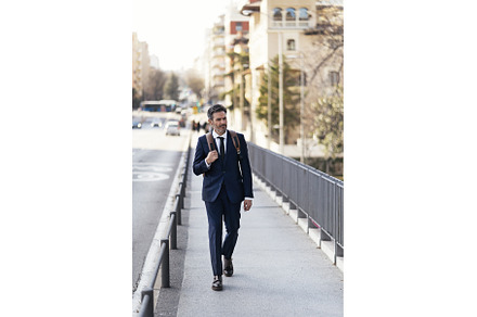 Handsome businessman walking in city, a Person Photo by nunezimage