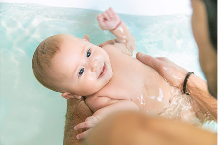The father bathes the little baby, a Person Photo by yanadjana