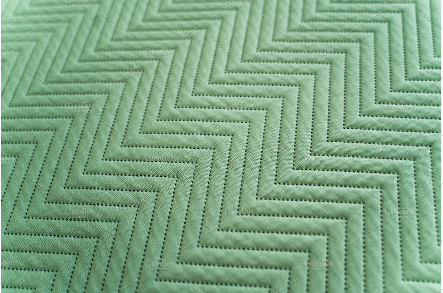 Diagonal closeup of green stitched, a Background Photo by volodymyrshtun13795