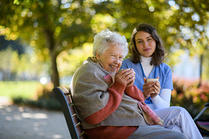 Elderly woman enjoying cup of coffee