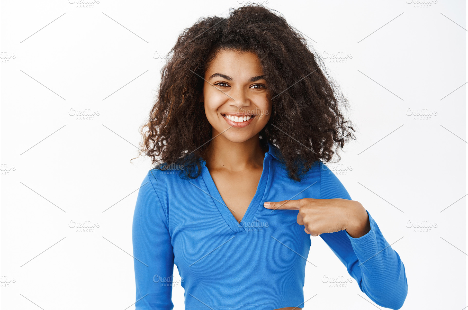 Smiling Black woman pointing at, a Person Photo by Cookie Studio
