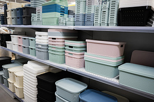 Assorted plastic storage boxes stacked neatly on store shelves, a Photo by AS photostudio