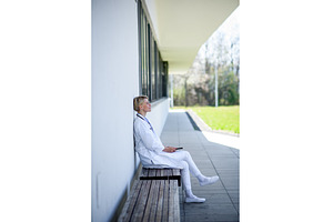 Young female doctor taking a break, a Person Photo by HalfPoint