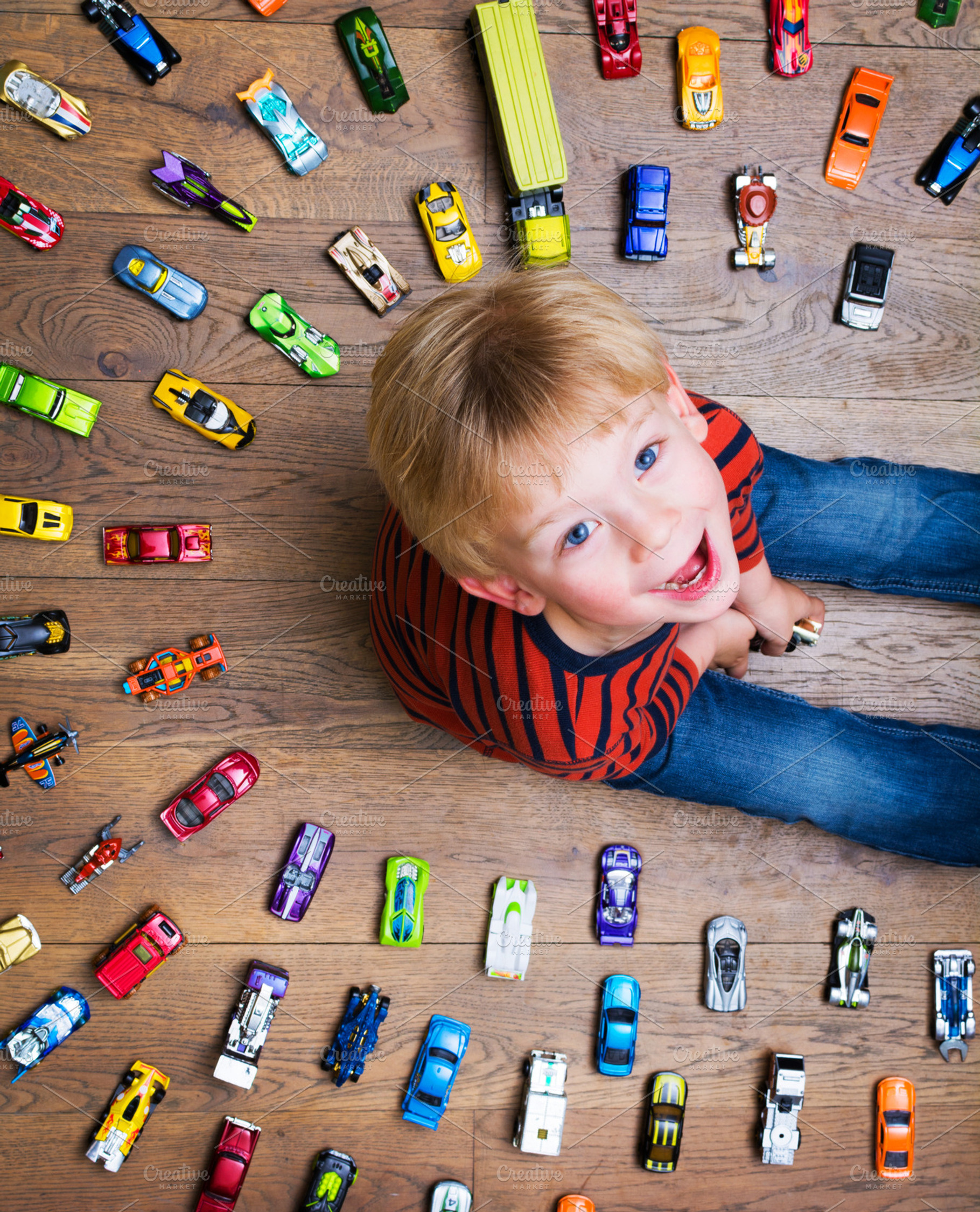 Boy with toy cars stock photo containing kid and birthday, a Person Photo by Twin Design