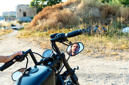 Male reflection on a chopper rear view mirror, a Person Photo by 2Design