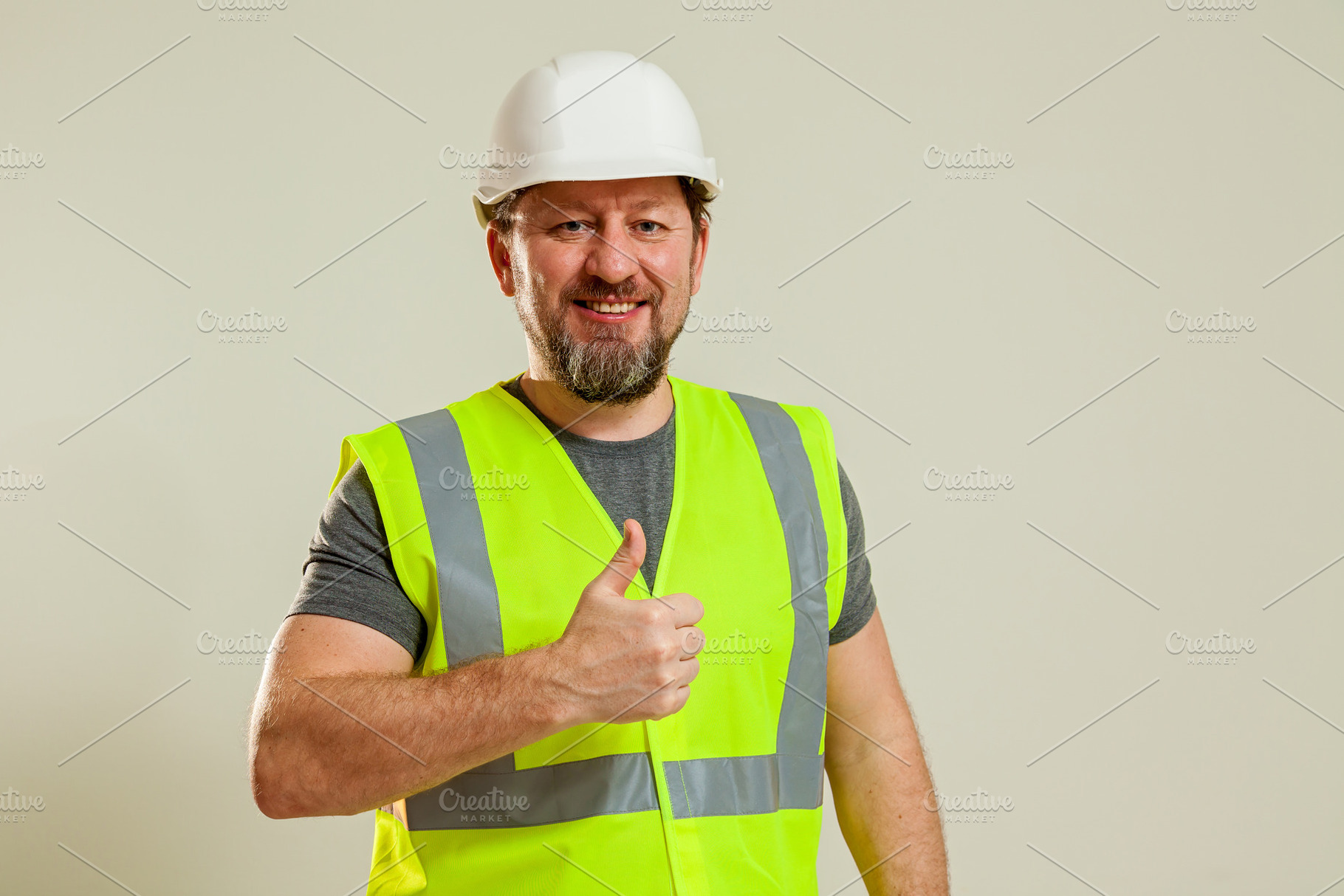 worker in a vest and white helmet, a Person Photo by Photostock