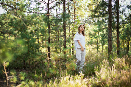 A child exploring a serene forest trail on a sunny day, surround, a Person Photo by Olena Rudo