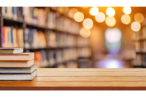 Stack of books on wooden table, a School & Education Photo by Igor Tichonow
