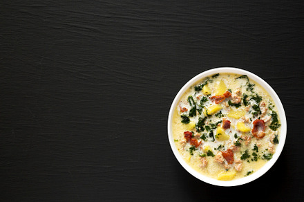 Homemade Zuppa Toscana with Kale and Bread in a white bowl on a, a Food & Drink Photo by LiudmylaChuhunova