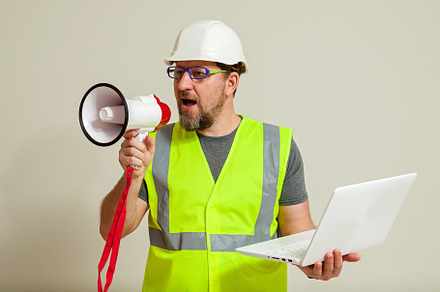 worker in a vest and white helmet, a Person Photo by Photostock