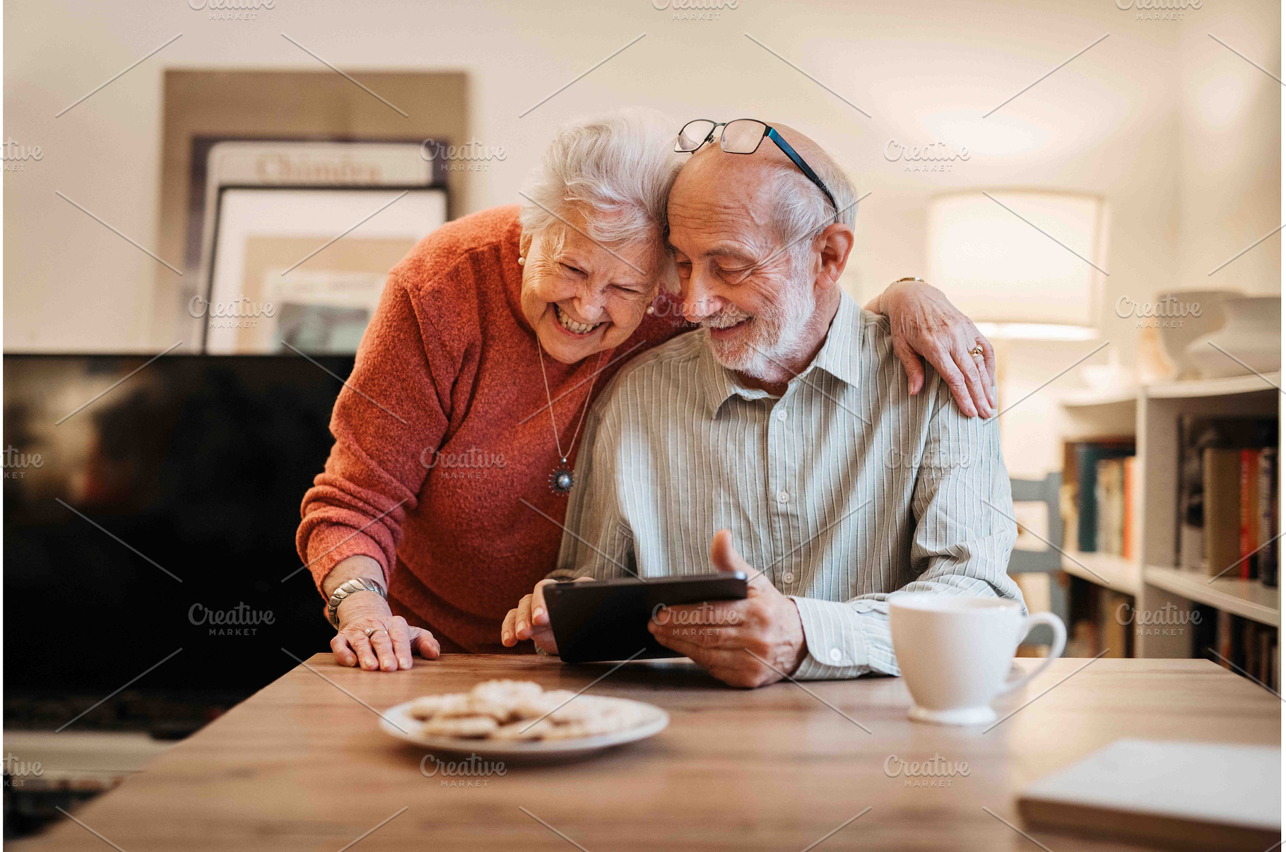 Elderly couple enjoying technology, a Technology Photo by HalfPoint