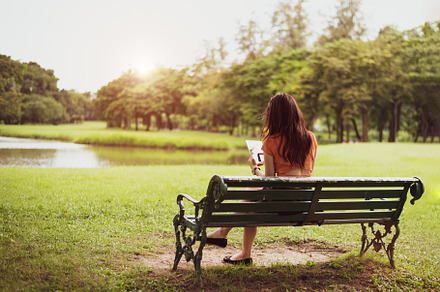 Back view of happy beauty woman in casual outfits using tablet i, a Person Photo by Ministocker