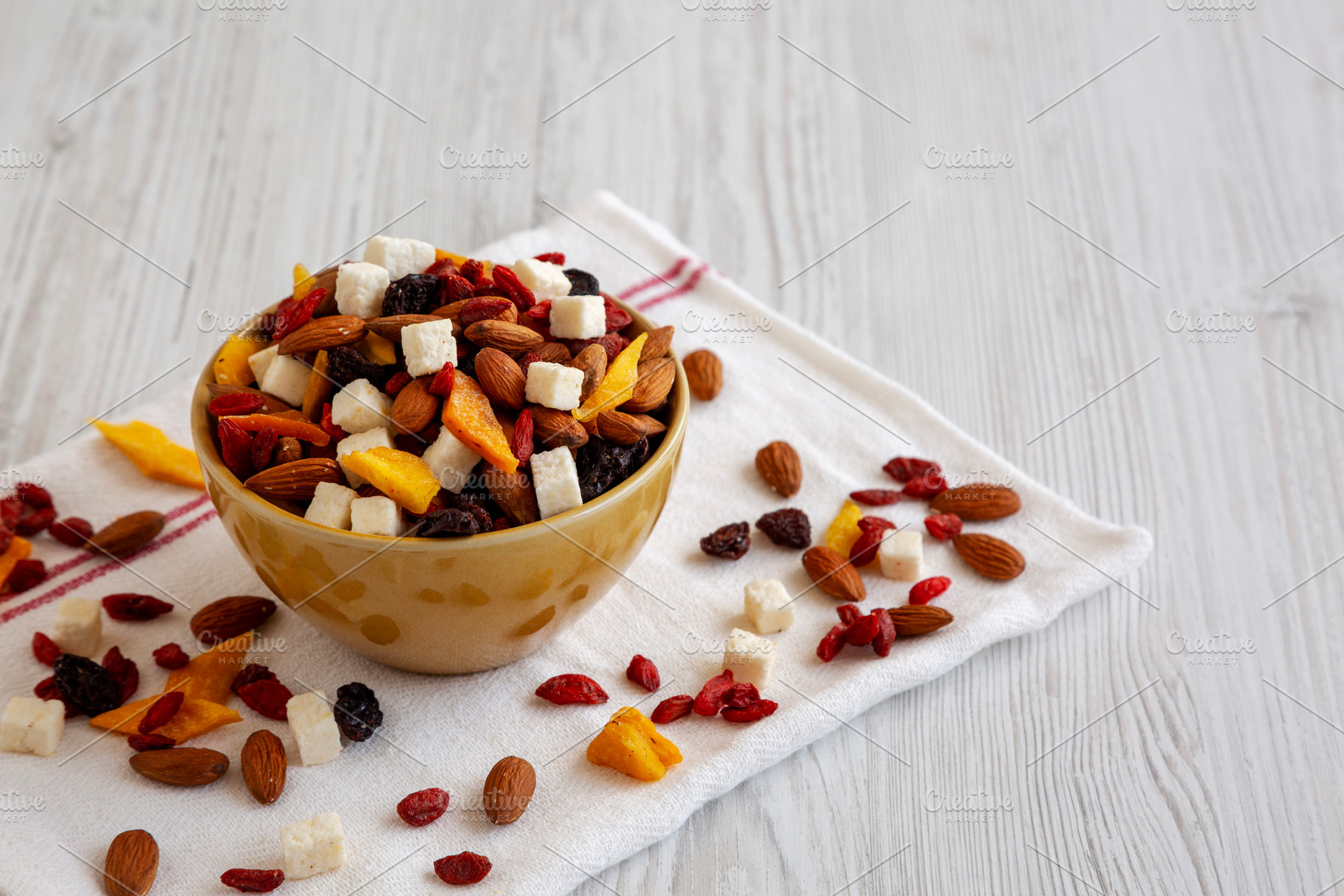 Healthy Dried Fruit and Nut Mix in a Bowl, side view. Space for, a Food & Drink Photo by LiudmylaChuhunova